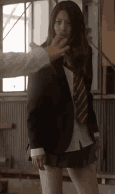 a woman in a suit and tie is being touched by a man .
