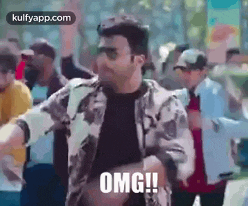 a man is dancing in front of a crowd of people and saying omg .
