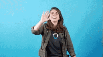 a woman is waving her hand in front of a blue background