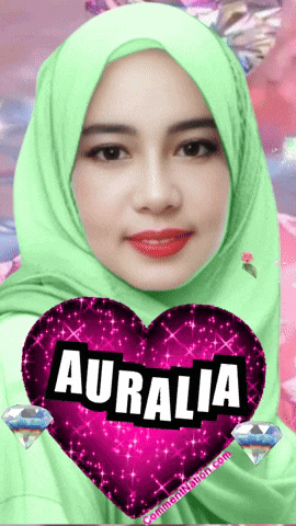 a woman wearing a green hijab holds a pink heart with the name auralia on it