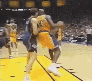 a basketball player with the number 13 on his jersey is fighting another player