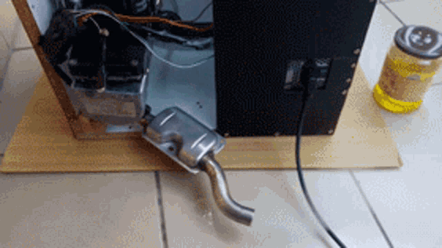a bottle of honey sits next to a computer