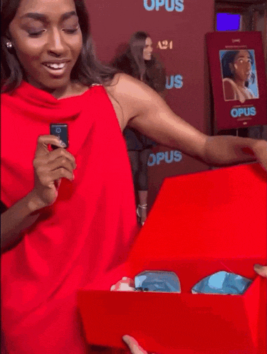 a woman in a red dress says " this is like my nightmare " on a red carpet