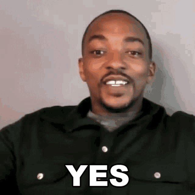 a man with a beard and mustache is smiling and saying `` yes '' .