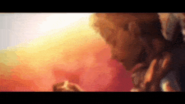 a close up of a person 's face with a blurred background and a sunset in the background .