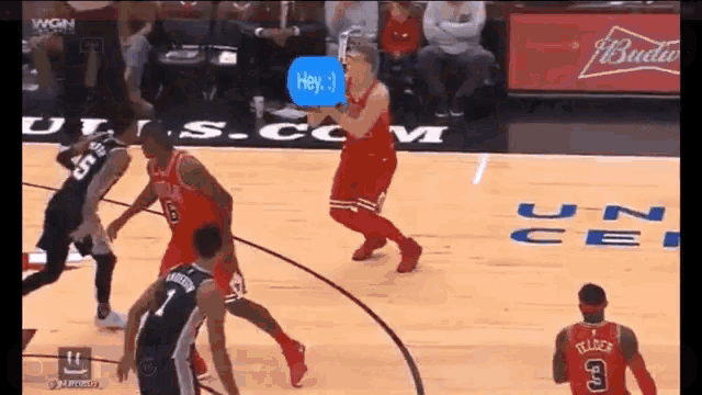 a basketball game is being played in front of a budweiser banner