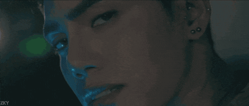 a close up of a woman singing into a microphone with the letters zx visible