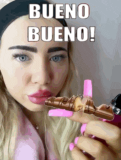 a woman is holding a piece of chocolate that says bueno bueno on it