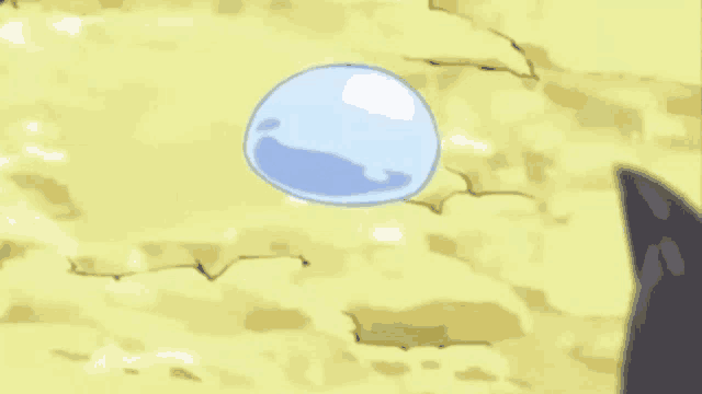 a blue slime with a face on it is floating in the air on top of a yellow surface .