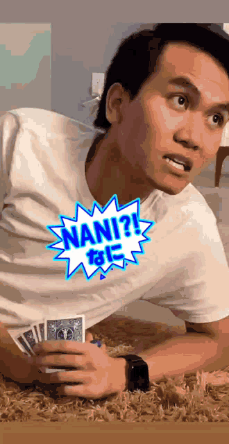 a man laying on the floor with a sticker that says " nani " on it