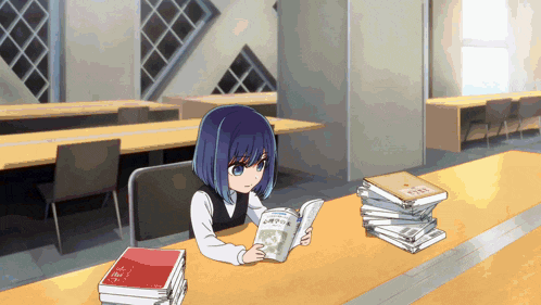 a girl sits at a table reading a book with a stack of books on the table