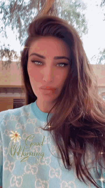 a woman wearing a sweater that says good morning on it