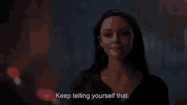 a woman is smiling and saying `` keep telling yourself that . ''