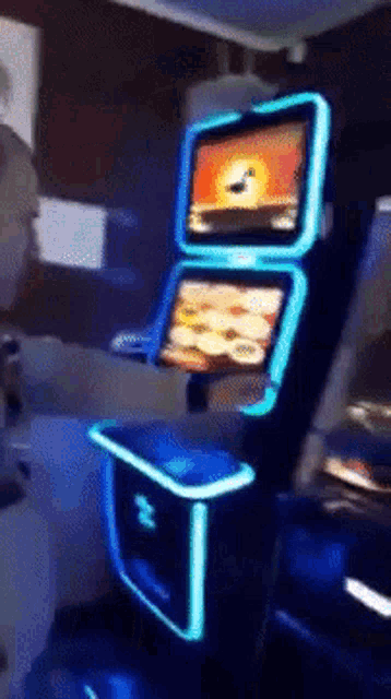 a man is playing a video game with a blue light behind it