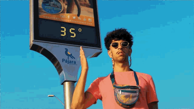 a man standing in front of a sign that says pajara on it