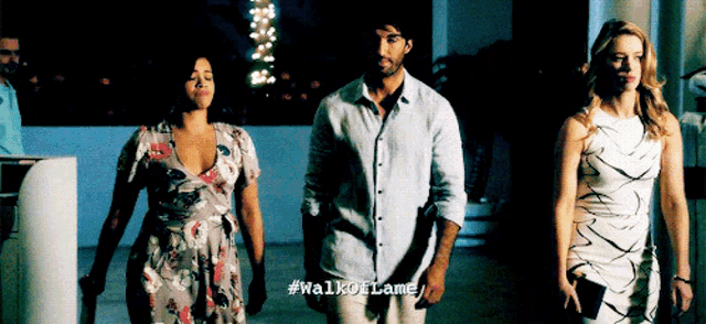 a man and two women standing next to each other with #walkofflame written on the screen