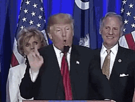 donald trump is giving a speech at a podium while a woman wipes her nose
