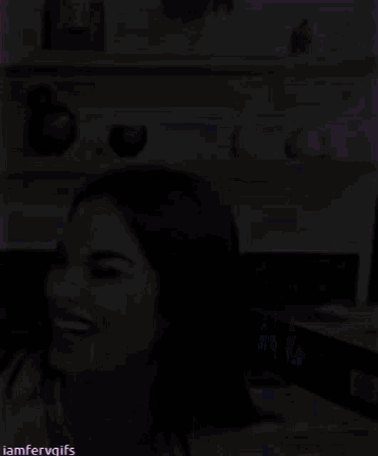 a woman is smiling in front of a shelf that says iamfervgifs on the bottom