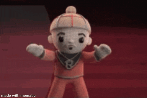 a stuffed toy with a hat and a necklace is standing on a red floor .