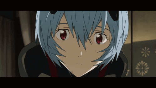 a close up of a person 's face with blue hair