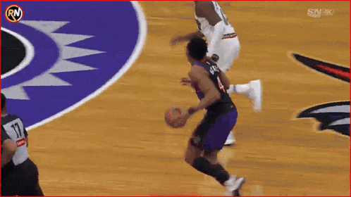 a basketball player wearing a number 17 jersey dribbles the ball