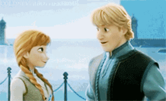 a man and a woman are looking at each other in front of a body of water