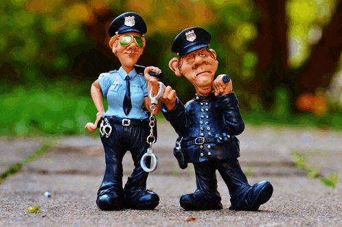 a man and a woman standing next to each other with one holding a handcuffs