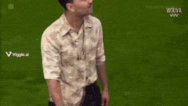 a man in a white shirt is standing in front of a black background and looking at the camera .
