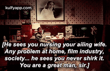a man is sitting in a living room with a picture of a woman on the wall and a quote from kulfyapp.com
