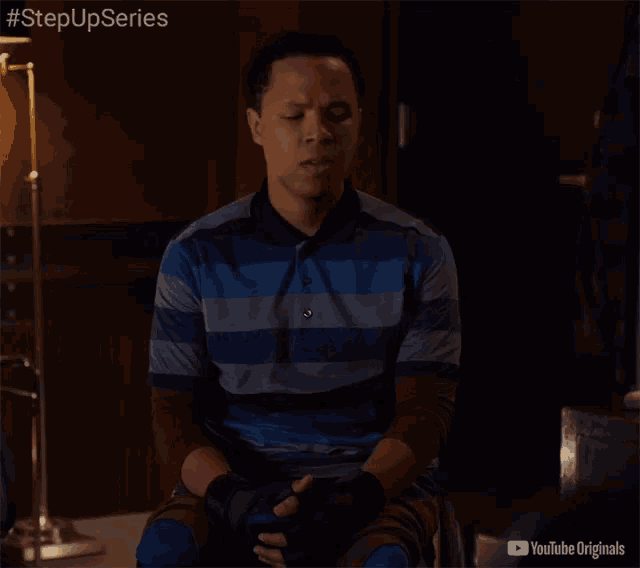 a man in a blue and gray striped shirt is sitting in a chair with youtube originals written on the bottom right