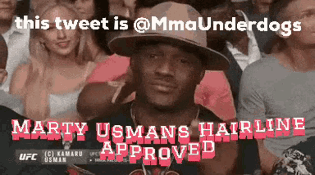 a man wearing a hat is sitting in a crowd of people with the caption martiy usmans hairline approved