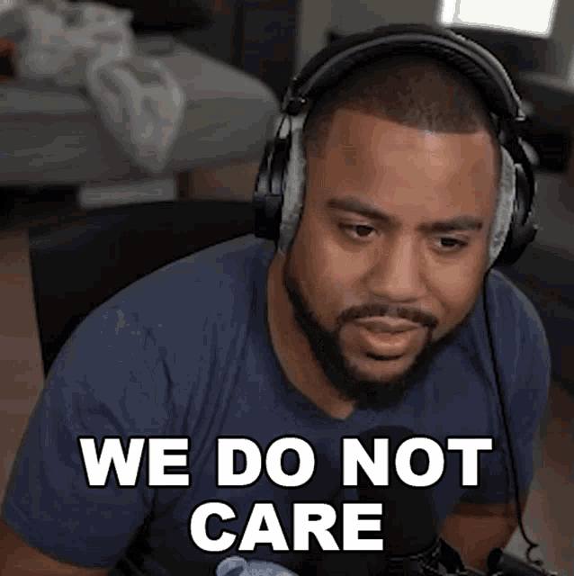 a man wearing headphones says " we do not care " in front of a microphone