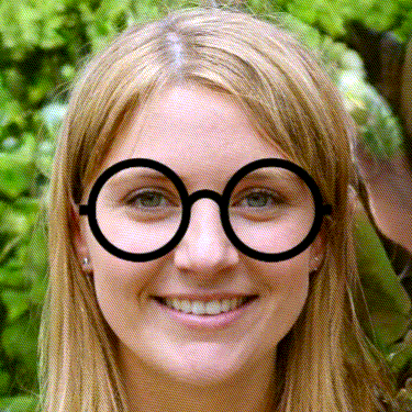 a close up of a woman 's face with a pair of round glasses on