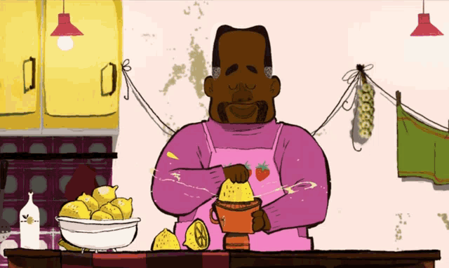 a man in a pink apron is squeezing lemons into a cup