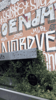 a brick wall has graffiti on it including the word nordve