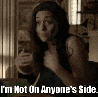 a woman is sitting at a table with the words i 'm not on anyone 's side above her .