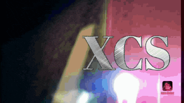 the word xcs that is on a pink and black background