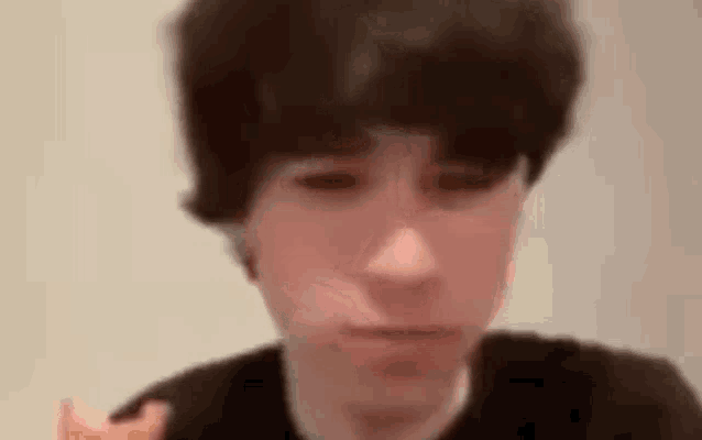 a close up of a young man eating a donut .
