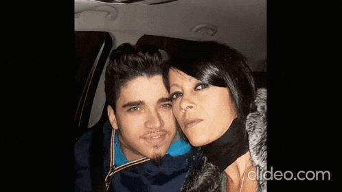 a man and a woman are posing for a picture in a car