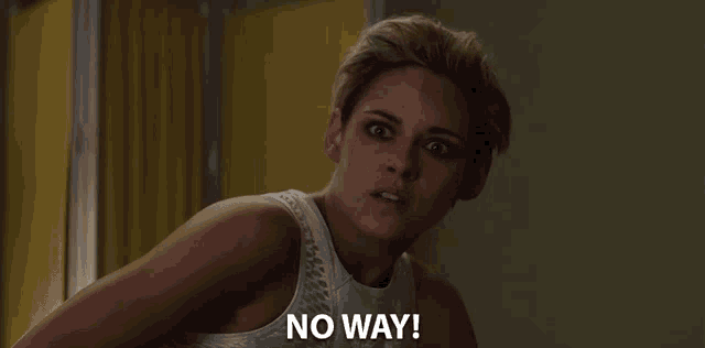 a woman in a white tank top says no way in front of a yellow curtain