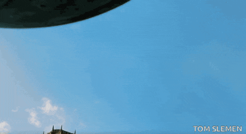 a picture of an ufo flying over a cathedral taken by tom slemen