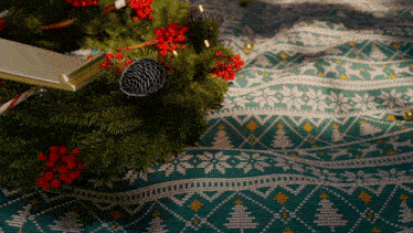 a green and white sweater with a christmas tree pattern