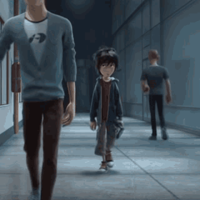 a man and a boy are walking down a hallway and the boy is wearing a hoodie