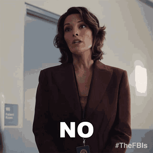 a woman in a burgundy suit says " no "