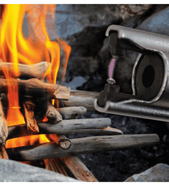 a close up of a fire with a lighter in the foreground