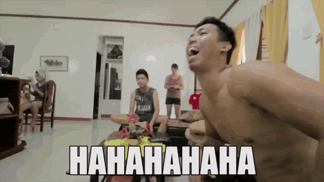 a man without a shirt is laughing in a living room with the words hahahahaha written on the bottom
