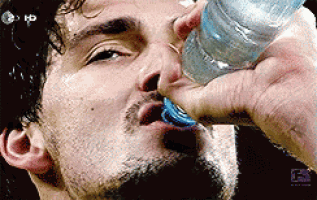 a man drinking water from a bottle with a hd logo on the bottom right