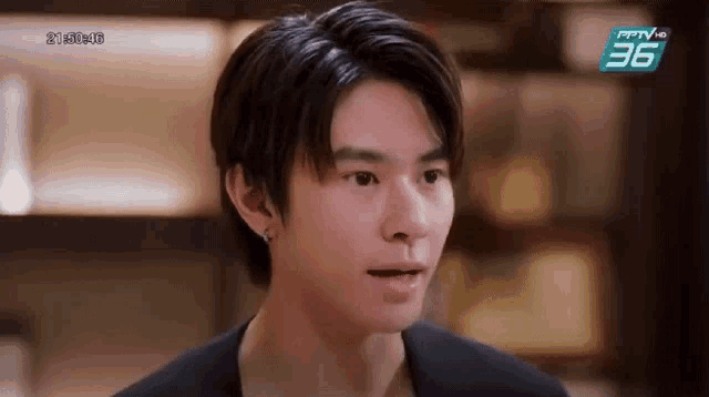 a close up of a young man 's face in a restaurant .