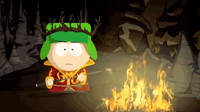 a cartoon character with antlers on his head is standing in front of a campfire