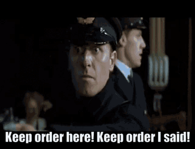 two men in uniform are standing next to each other and one of them is saying keep order here ! keep order i said !